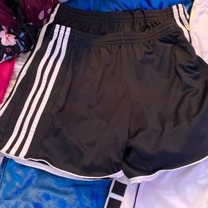2 black shorts one medium and one small,top right is small and bottom is medium